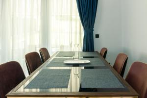a dining room with a table and chairs at Villa Fiori in Vrelo Bosne