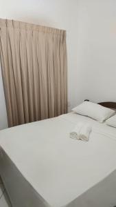 un letto bianco in una stanza con tenda di BRISAS DO MAR HOTEL a Valença