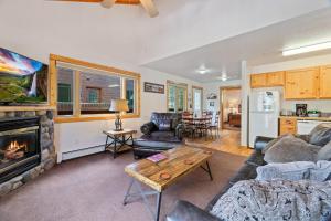 un salon avec un canapé et une cheminée dans l'établissement Bugle Pointe B11 by Estes Park Condos, à Estes Park