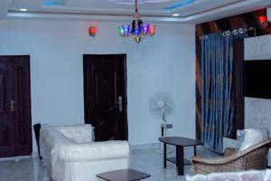 a living room with a couch and a table at Feyintola Shortlet Apartment in Ondo