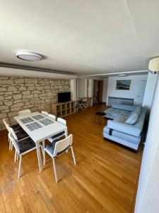 a living room with a table and a couch at Villa Rozika in Baška Voda