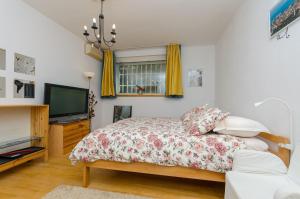 a bedroom with a bed and a flat screen tv at Apartment Z4 in Split