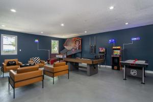a living room with a pool table and a game room at Massive Asheville Compound A Memorable Experience in Weaverville +73 photos