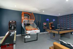 a room with a play room with a pool table and a table at Massive Asheville Compound A Memorable Experience in Weaverville