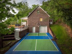 a tennis court in front of a house at Massive Asheville Compound A Memorable Experience in Weaverville