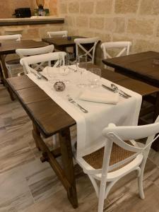 a table with a white table cloth on it at Palazzo Mellacqua in Andrano