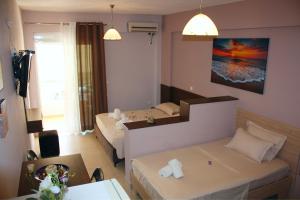 a small room with two beds and a table at Studio Beleri in Himare