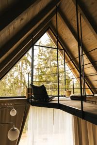 a room with a large window in a roof at ZlatAir Twins in Nova Varoš