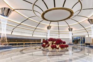 a lobby with a large ceiling with red flowers at Fontainebleau Las Vegas in Las Vegas