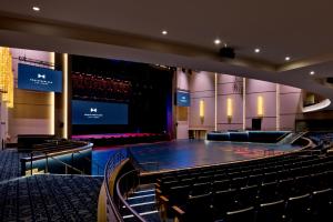 an empty auditorium with a stage and chairs at Fontainebleau Las Vegas in Las Vegas