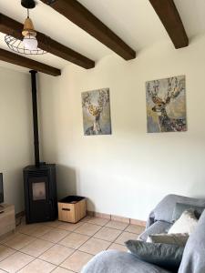 a room with two pictures of deer on the wall at EL CANTÓN, Castillo de Villamalefa in Castillo de Villamalefa