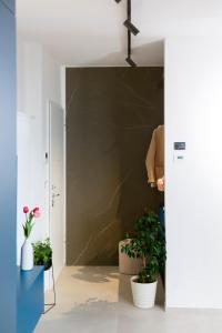 a hallway with potted plants and a wall at Aschitelli luxury retreat in Polignano a Mare