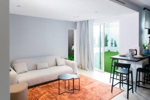 a living room with a couch and a table at Aschitelli luxury retreat in Polignano a Mare