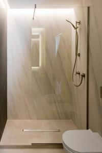 a bathroom with a shower and a toilet at Aschitelli luxury retreat in Polignano a Mare +9 photos