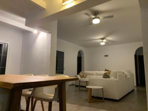 a living room with a table and a couch at Villa Nodrog in Costa de Antigua