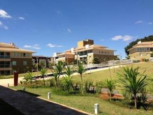 a view of a park with palm trees and buildings at The Sun Maravilhoso in Brasília