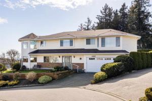 a large white house with a garage at View of Ocean & MOUNT BAKER in White Rock