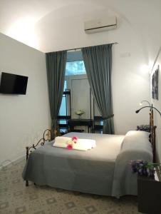 a bedroom with a bed with a mirror and a television at Splendore del Sole in Polignano a Mare