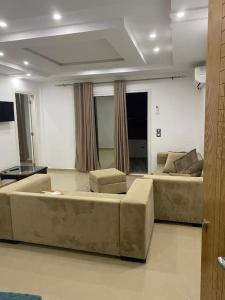 a living room with two couches and two chairs at CASA Di AMROU:grande terrasse,position stratégique in Tazarka +11 photos