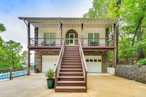a home with a staircase leading up to a house at Secluded Branson Escape with Pool and Game Room! in Branson