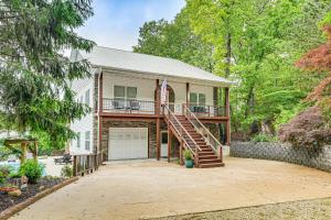 a house with a deck and a garage at Secluded Branson Escape with Pool and Game Room! in Branson
