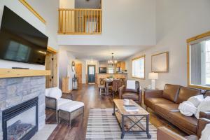 a living room with a couch and a fireplace at Nisswa Townhome with Boat Slip and Gull Lake Access! in Nisswa