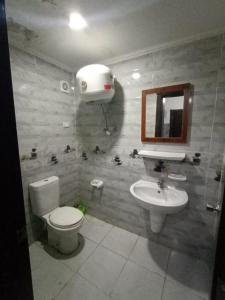 a bathroom with a toilet and a sink at BTM RENTAL CHALETS PORTO MATROUH FAMiLY ONLY in Marsa Matruh