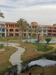 a view of a resort with a pool and a playground at BTM RENTAL CHALETS PORTO MATROUH FAMiLY ONLY in Marsa Matruh