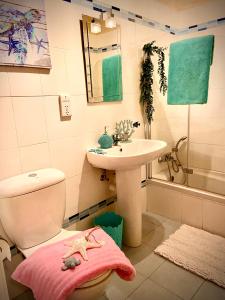 a bathroom with a sink and a toilet and a sink at Farmhouse Grazzja with pool in Qala
