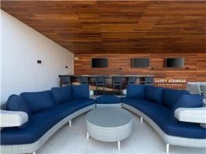 a room with blue couches and a table and chairs at Trendy 1 BR apartment in Cruz Con Mar Brand New Building in Playa del Carmen