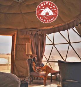 a room with a bed and a sign in a yurt at Rosella rum camp in Wadi Rum