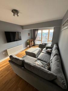 a living room with a large couch in a living room at Luxury 2 bed fully equipped city centre apartment in Cork