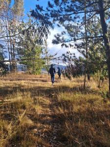 two people walking down a trail in a field at Weninger Lodge in Urubamba