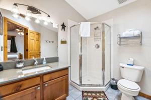 a bathroom with a shower and a toilet and a sink at Bugle Pointe A01 by Estes Park Condos in Estes Park
