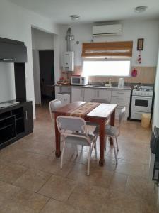 a kitchen with a wooden table and chairs at Milli in Gualeguaychú