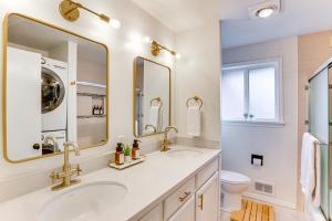 a bathroom with two sinks and a toilet at Vibrant Tacoma Retreat, Near Point Defiance Park! in Tacoma +19 photos