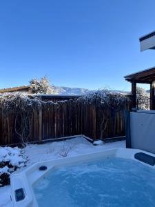 a hot tub in a yard covered in snow at 1920's Farmhouse In Town With Hot Tub &mntn Views in Buena Vista
