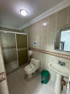 a bathroom with a toilet and a shower and a sink at HOTEL PLAZA REAL SUR in Cali