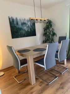 a dining room table with four chairs around it at mf Guesthouse in Sukow