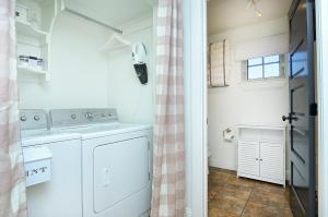 a laundry room with a washer and dryer at 1920's Farmhouse In Town With Hot Tub &mntn Views in Buena Vista