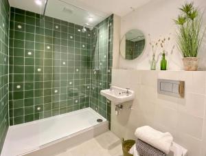 約克的住宿－Victoria Bar Walls by Chateau Anna, Central York - free parking，绿色瓷砖浴室设有浴缸和水槽