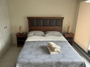 a bedroom with a bed with a pillow on it at Departamento Estudio, entero in Temuco