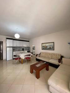 a living room with a couch and a table at Alvi Apartment 1 in Sarandë