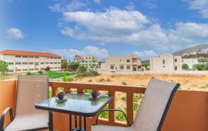 a table and chairs on a balcony with a view at Kaiti 's Studios & Apartments in Palaiochóra