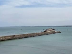 a pier in the middle of a body of water at Duplex Statia vue sur Port in El Jadida