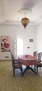 a room with a table and chairs and a window at Villa chez NADA in Essaouira