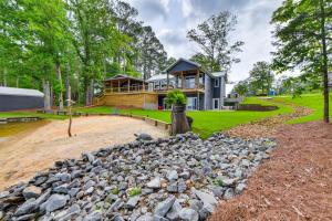 een huis met een rotstuin ervoor bij Beachfront Dadeville Family Escape on Lake Martin! in Dadeville