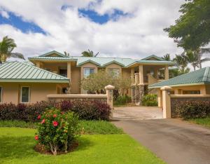 a house with green roofs and a driveway at MAJESTIC OCEAN Majestic Mauna Kea Condo with Golf and Ocean Views in Hapuna Beach