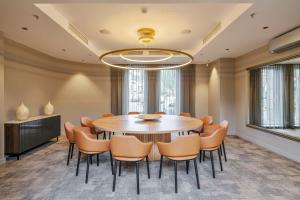 a dining room with a table and chairs at Radisson Hotel Kaunas in Kaunas
