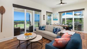 a living room with a couch and a table at MAUNA KEA SUNSETS Gorgeous 2BR Kumulani Condo with Ocean Sunset View in Hapuna Beach